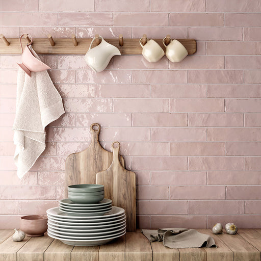 Kitchen featuring Nomad Rose brick wall tiles in a 6 × 24.6cm format, laid horizontally to create a soft pink, industrial-inspired splashback.