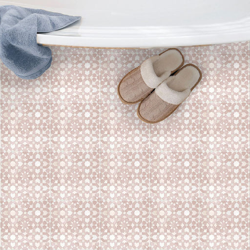 Bathroom floor featuring Berber Tetuan Rose 15×15cm Moroccan-style porcelain tiles, showcasing a soft pink geometric pattern styled with slippers beside a bathtub.