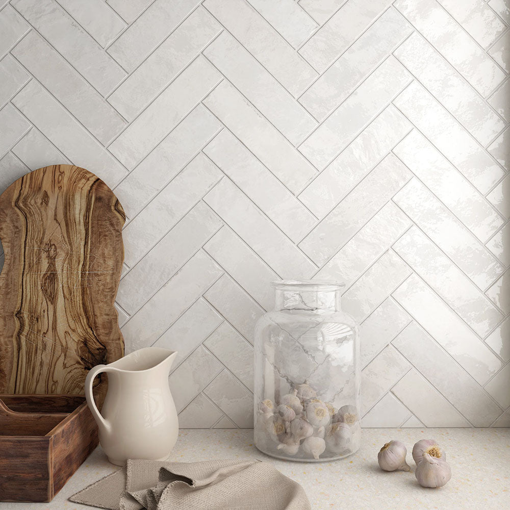 Kitchen featuring Nomad White brick wall tiles in a 6 × 24.6cm format, laid in a herringbone pattern to create a clean, industrial-inspired splashback.
