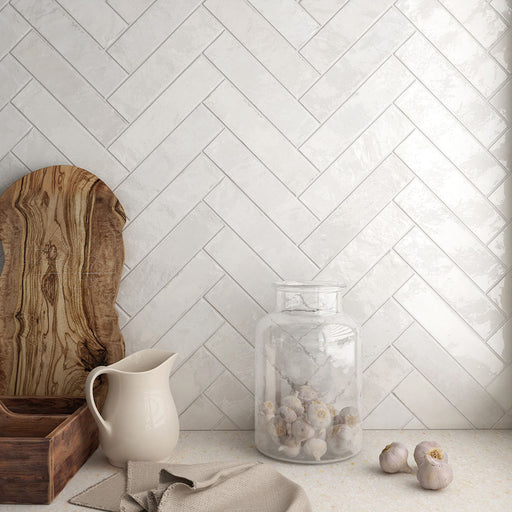Kitchen featuring Nomad White brick wall tiles in a 6 × 24.6cm format, laid in a herringbone pattern to create a clean, industrial-inspired splashback.