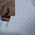 Ivy Blue Victorian Moroccan style 20x20cm patterned tiles, shown as a floor installation beneath a table to highlight the repeating blue and white geometric design.