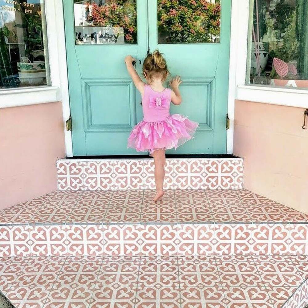 Ivy Rose Victorian Moroccan style 20x20cm patterned tiles, used on outdoor steps to create a decorative pink and white geometric entrance feature.