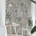 Interior corner featuring Meadow Flowers Decor 60 × 120cm porcelain wall tiles, styled with a small dining table, wooden chair, indoor plants, and soft natural light for a calm, nature-inspired setting.