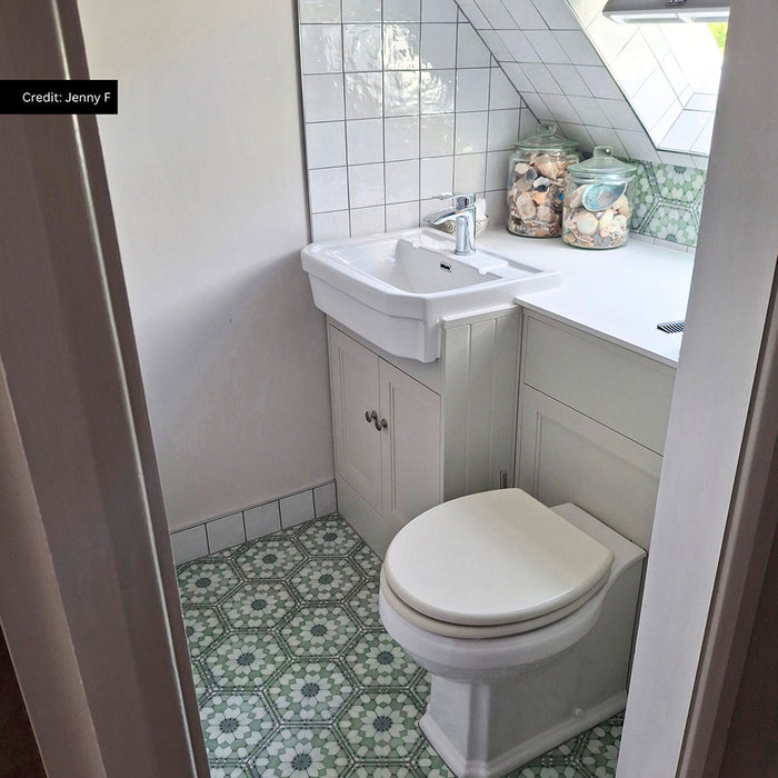 Traditional cloakroom featuring Medina Soft Green Moroccan style hexagon floor tiles, paired with white square wall tiles, a classic white vanity unit, a chrome tap and soft sage green accents for a bright, characterful space.