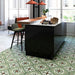 Contemporary kitchen featuring Mediterraneo Corfu 2cm patterned outdoor slabs 50 × 100cm, showcasing a decorative Mediterranean-inspired pattern in green, cream, and terracotta tones, paired with sleek black cabinetry and warm wood accents.