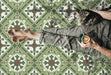 Close-up of Mediterraneo Corfu 2cm patterned outdoor slabs 50 × 100cm, featuring a decorative Mediterranean-inspired pattern in green, cream, and terracotta tones with a vintage-style finish and geometric detailing.