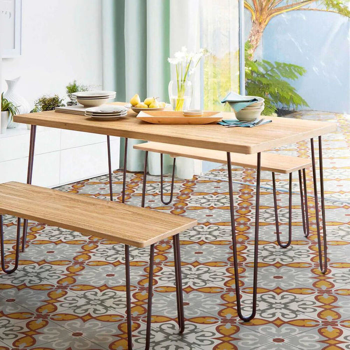 Dining area featuring Mediterraneo Gela 2cm patterned outdoor slabs 50 × 100cm, showcasing a decorative Mediterranean-inspired pattern in warm terracotta, grey, and white tones, paired with natural wood dining furniture and soft neutral interiors.