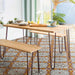 Dining area featuring Mediterraneo Gela 2cm patterned outdoor slabs 50 × 100cm, showcasing a decorative Mediterranean-inspired pattern in warm terracotta, grey, and white tones, paired with natural wood dining furniture and soft neutral interiors.