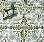Close-up of Mediterraneo Olbia 2cm patterned outdoor slabs 50 × 100cm, featuring a faded Mediterranean-inspired floral design in soft green, blue, and terracotta tones with a decorative vintage-style finish.