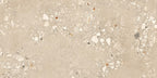Close-up of Melange Sand Cosmo Stone wall and floor tiles 60 × 120cm, featuring warm sand-toned stone-effect detailing with terrazzo-inspired aggregate texture, subtle tonal variation, and a refined contemporary matt finish.