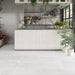 Bright botanical interior featuring Melody Cement White 30 × 60cm concrete-effect porcelain floor tiles, showcasing soft white tones and a subtle industrial texture, paired with natural wood finishes, layered greenery, and light-filled contemporary styling.