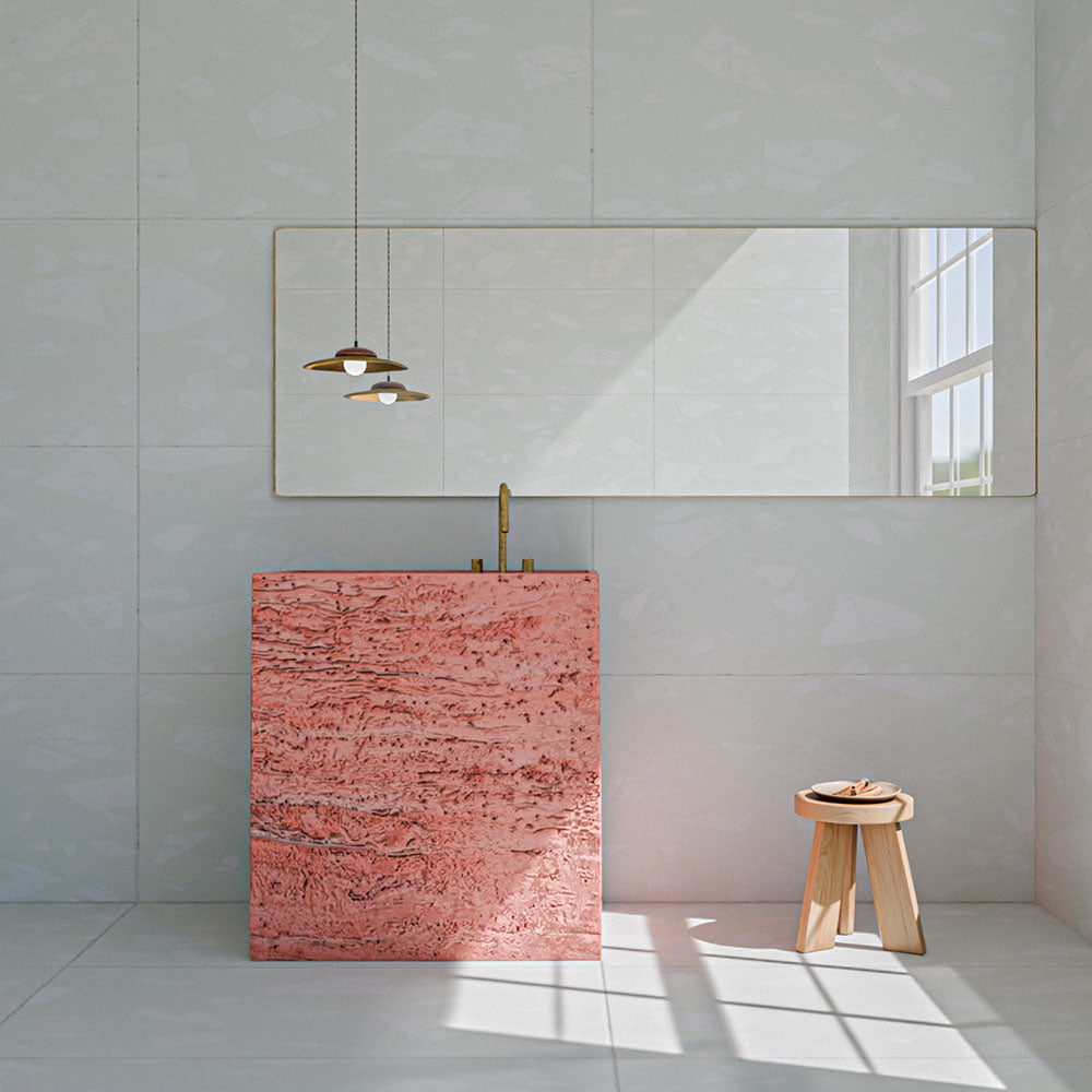 Bathroom featuring Melody ROCK Terrazzo White 60cm x 120cm wall and floor tiles, paired with a statement pink stone vanity, brass fixtures, large mirror and minimalist wooden stool.
