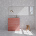 Bathroom featuring Melody ROCK Terrazzo White 60cm x 120cm wall and floor tiles with a large-scale terrazzo effect, paired with a statement pink vanity, brass fixtures and warm wood details.