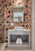 Modern bathroom featuring Melody ROCK Terrazzo Pink 60 × 60cm porcelain wall tiles, showcasing oversized black marble-effect fragments across a warm pink terrazzo-inspired surface, paired with concrete styling, minimalist fittings, and crisp white sanitaryware for a bold contemporary finish.