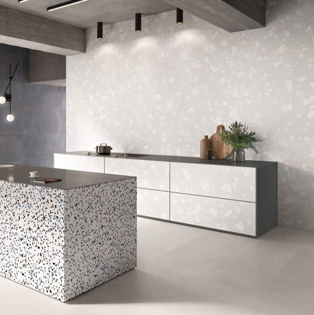 Contemporary kitchen featuring Melody ROCK Terrazzo White 60 × 120cm terrazzo-effect porcelain wall tiles, showcasing oversized white stone fragments on a soft pale base, paired with minimalist cabinetry, concrete finishes, and a statement terrazzo island for a modern architectural look.