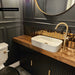Stylish cloakroom featuring Midas Antique Gold Vintage Crackle wall tiles in a 5cm x 25cm format, paired with dark panelled walls, a timber vanity unit, brass fittings and patterned floor tiles.