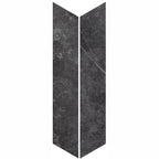 Product display of Monzo Stone Chevron Nite 10x53cm chevron porcelain tiles in deep charcoal tones, featuring subtle stone-effect texture, soft tonal variation and delicate veining inspired by natural stone surfaces.