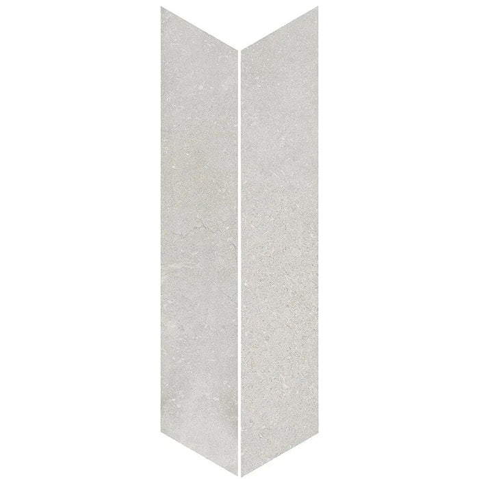 Product display of Monzo Stone Chevron Silver 10x53cm stone-effect porcelain chevron tiles in soft silver-grey tones, featuring subtle texture and natural tonal variation with a contemporary stone-inspired finish.