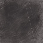 Product display of Monzo Stone Nite 60x60cm dark stone-effect porcelain tiles in deep charcoal tones, featuring dramatic tonal variation, textured detailing and natural stone-inspired movement across the surface.