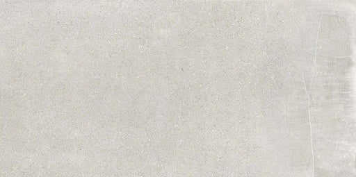 Product display of Monzo Stone Silver 30x60cm stone-effect porcelain tiles in soft silver-grey tones, featuring subtle texture and tonal variation with a natural stone-inspired finish.