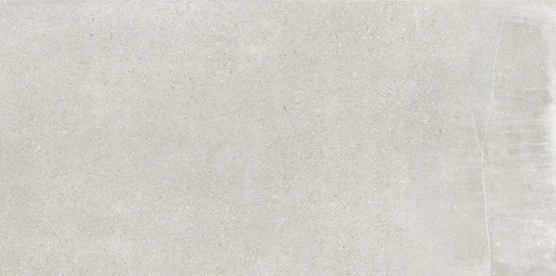Product display of Monzo Stone Silver 30x60cm stone-effect porcelain tiles in soft silver-grey tones, featuring subtle texture and tonal variation with a natural stone-inspired finish.