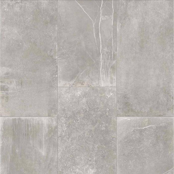 Product display of Monzo Stone Titanium 30x60cm stone-effect porcelain tiles in soft grey tones, featuring subtle texture, layered veining, and tonal variation with a natural stone-inspired finish.