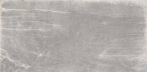 Product display of Monzo Stone Titanium 30x60cm stone-effect porcelain tiles in soft grey tones, featuring subtle texture, layered veining, and tonal variation with a natural stone-inspired finish.