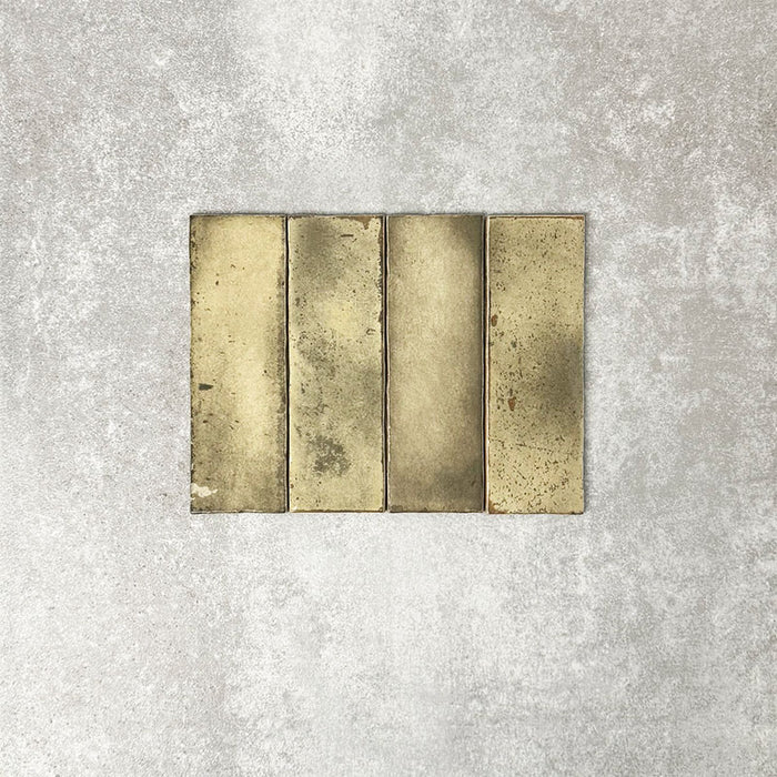 Close-up of Foundry Bricks Moss Green 6.5x20cm brick wall tiles, showcasing earthy green tones with rich tonal variation, lightly textured surfaces and gently irregular edges for a refined, contemporary finish.