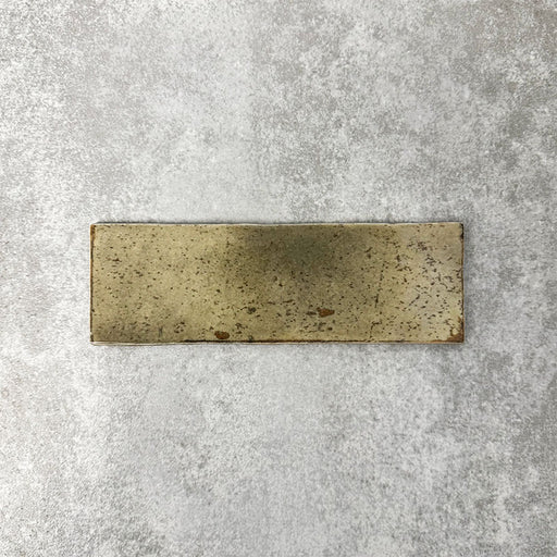 Close-up of Foundry Bricks Moss Green 6.5x20cm brick wall tile, showcasing earthy green tones with rich tonal variation, lightly textured surface and gently irregular edges for a refined, contemporary finish.