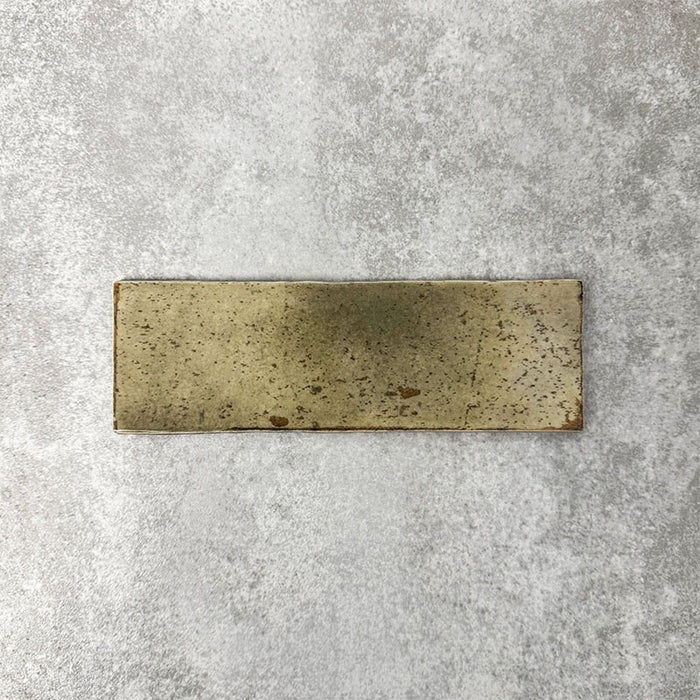 Close-up of Foundry Bricks Moss Green 6.5x20cm brick wall tile, showcasing earthy green tones with rich tonal variation, lightly textured surface and gently irregular edges for a refined, contemporary finish.