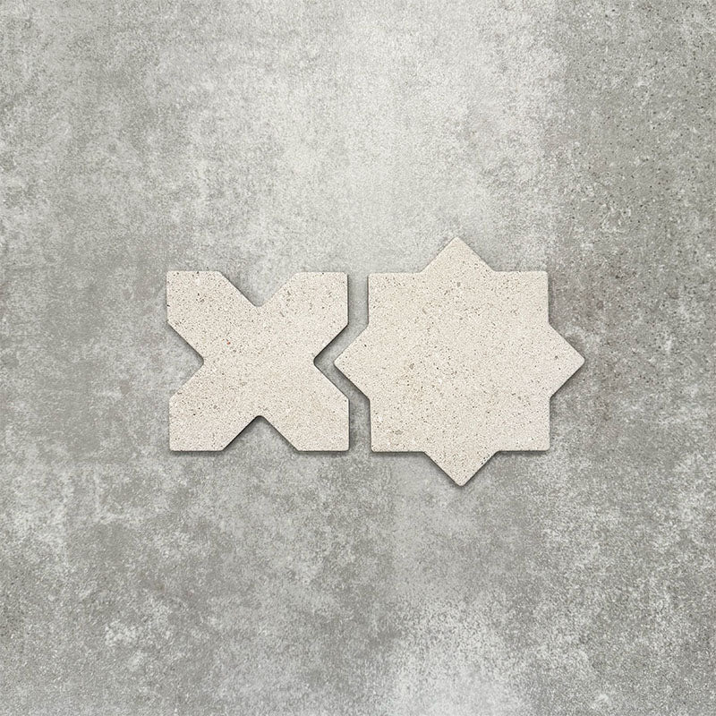 Close-up of Muscat Avorio Rocks Star and Cross wall and floor tiles, showcasing coordinating geometric shapes, soft ivory tones, subtle speckled detailing and a textured stone-effect finish.