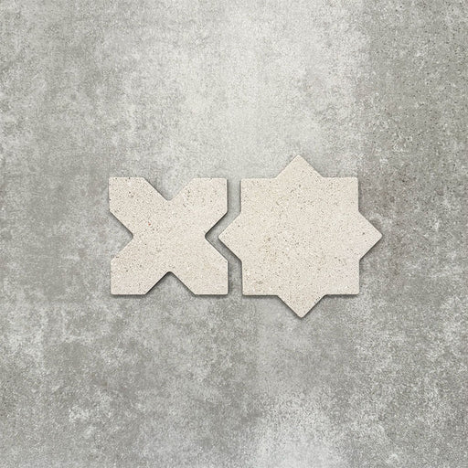 Close-up of Muscat Avorio Rocks Star and Cross wall and floor tiles, showcasing coordinating geometric shapes, soft ivory tones, subtle speckled detailing and a textured stone-effect finish.