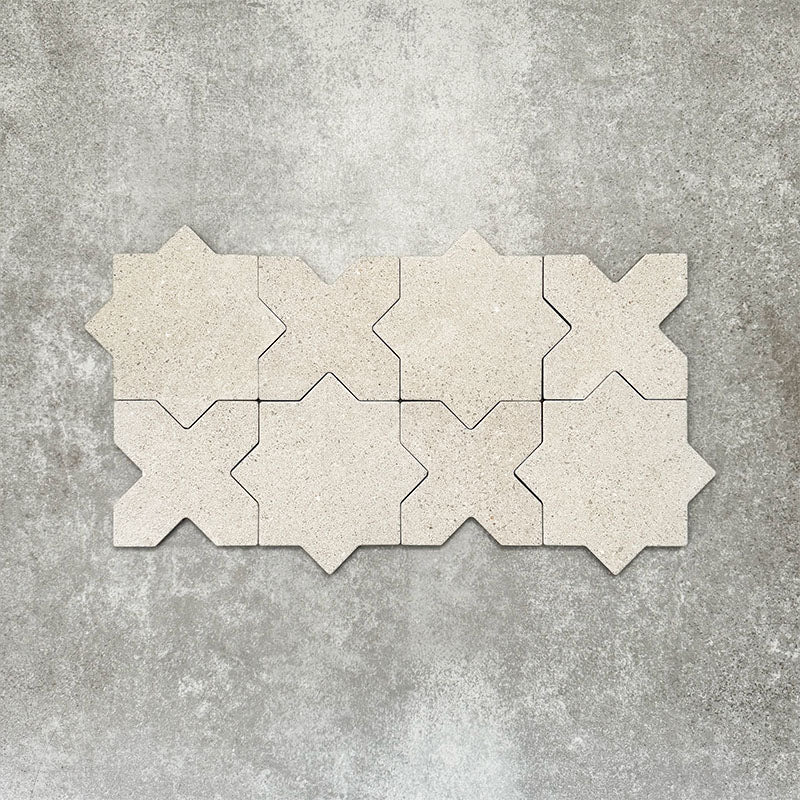Close-up of Muscat Avorio Rocks Star and Cross wall and floor tiles arranged in a repeating geometric pattern, showcasing soft ivory tones, subtle speckled detailing and a textured stone-effect finish.