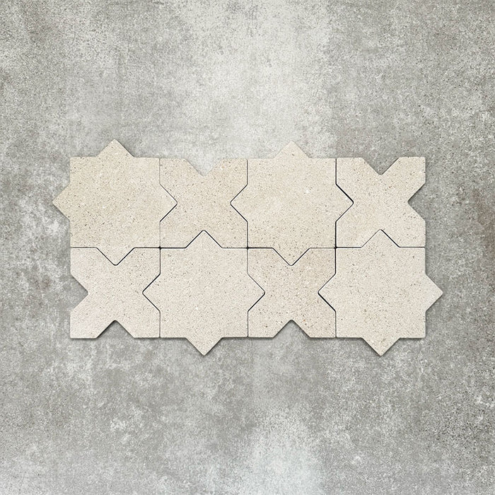 Close-up of Muscat Avorio Rocks Star and Cross wall and floor tiles arranged in a repeating geometric pattern, showcasing soft ivory tones, subtle speckled detailing and a textured stone-effect finish.