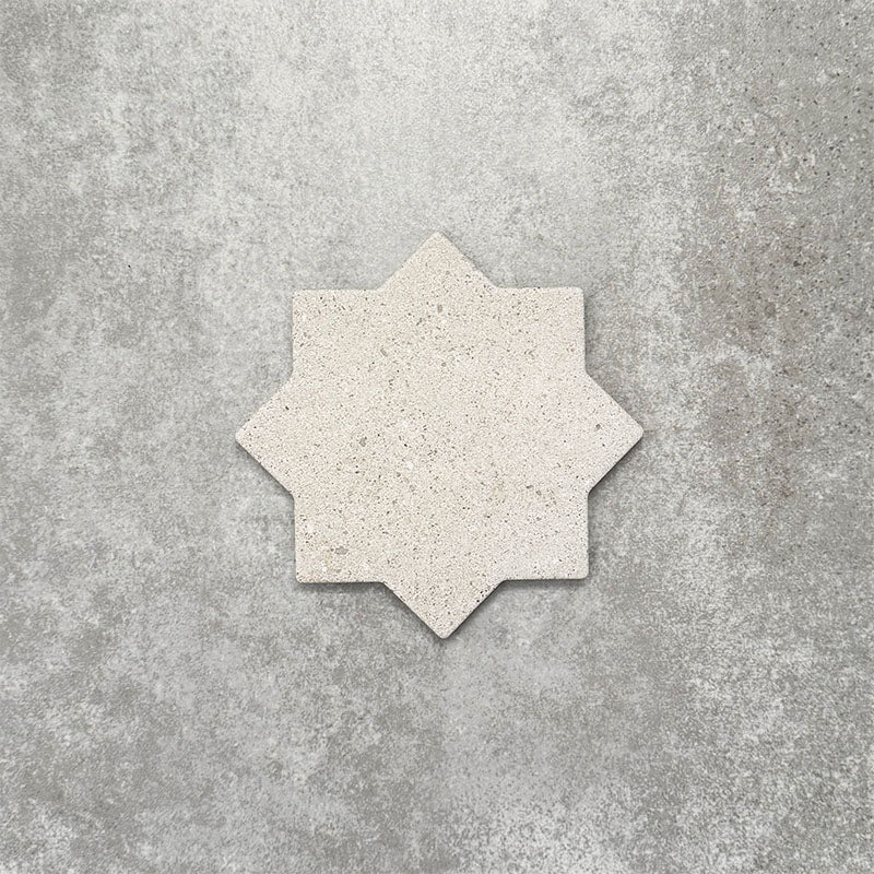 Close-up of Muscat Avorio Rocks Star wall and floor tile, showcasing an eight-point geometric star shape, soft ivory tones, subtle speckled detailing and a textured stone-effect finish.