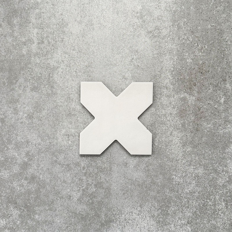 Close-up of Muscat Bone Cross Moroccan-style porcelain wall and floor tile, showcasing a distinctive geometric cross shape, soft bone white tone and smooth matt finish.