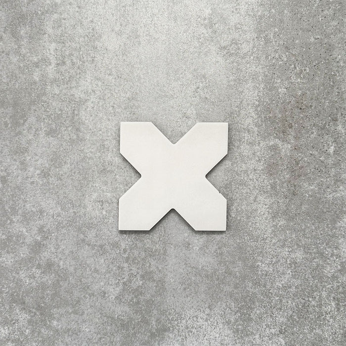 Close-up of Muscat Bone Cross Moroccan-style porcelain wall and floor tile, showcasing a distinctive geometric cross shape, soft bone white tone and smooth matt finish.
