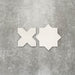 Close-up of Muscat Bone Star and Cross Moroccan-style porcelain wall and floor tiles, showcasing coordinating geometric shapes, soft bone white tones and a smooth matt finish.
