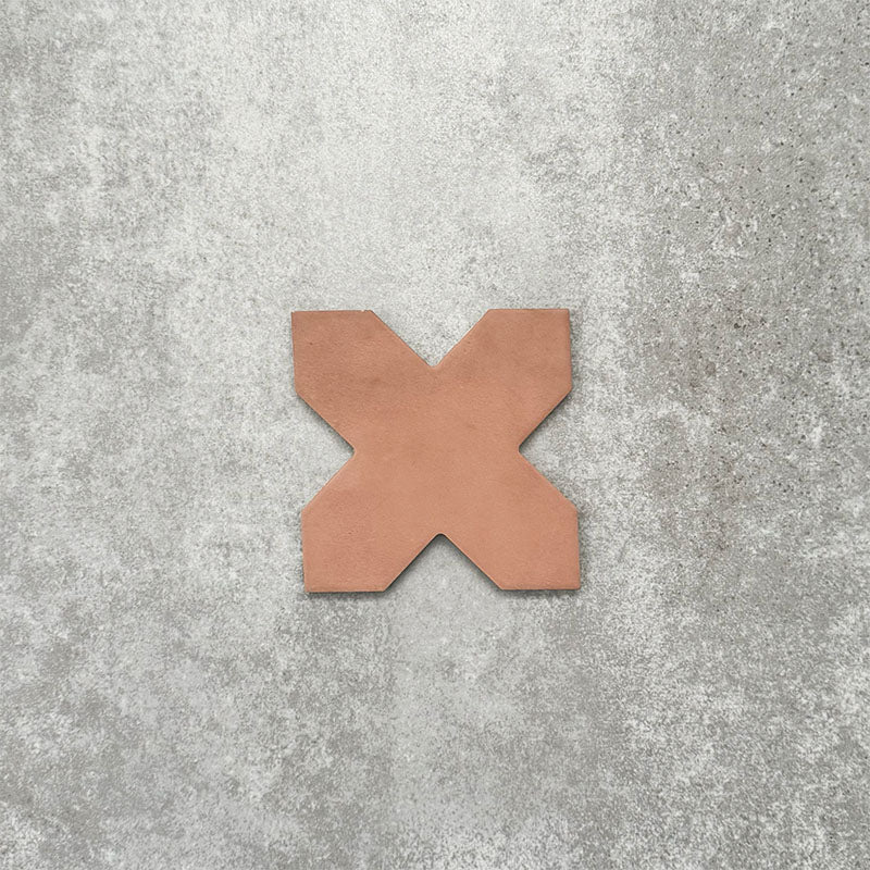 Close-up of Muscat Cotto Cross Moroccan-style porcelain wall and floor tile, showcasing a distinctive geometric cross shape, warm terracotta tone and smooth matt finish.