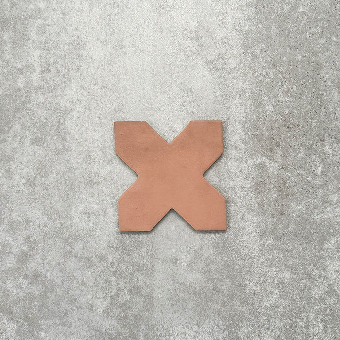 Close-up of Muscat Cotto Cross Moroccan-style porcelain wall and floor tile, showcasing a distinctive geometric cross shape, warm terracotta tone and smooth matt finish.