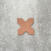Close-up of Muscat Cotto Cross Moroccan-style porcelain wall and floor tile, showcasing a distinctive geometric cross shape, warm terracotta tone and smooth matt finish.