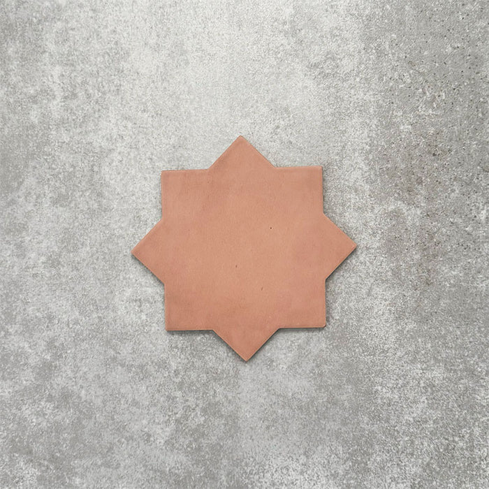 Close-up of Muscat Cotto Star Moroccan-style porcelain wall and floor tile, showcasing an eight-point geometric star shape, warm terracotta tone and smooth matt finish.