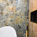Bathroom featuring Museo Warm Stone Matt 60x120cm porcelain wall tiles, showcasing a dramatic marble effect design in warm beige, ivory and grey tones, paired with a freestanding bath, brass fittings and textured feature wall tiles.