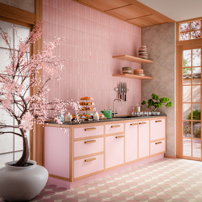 Interior featuring Nomad Rose brick-effect wall tiles, showcasing soft blush pink tones and a subtle handcrafted-inspired finish. Laid vertically across the full splashback, the tiles create height and texture while complementing the warm timber detailing and pastel cabinetry. The combination of pink hues, natural wood accents and contemporary styling creates a playful yet refined space that feels welcoming, modern and effortlessly on trend. Perfect for adding warmth, colour and personality to kitchens, bat
