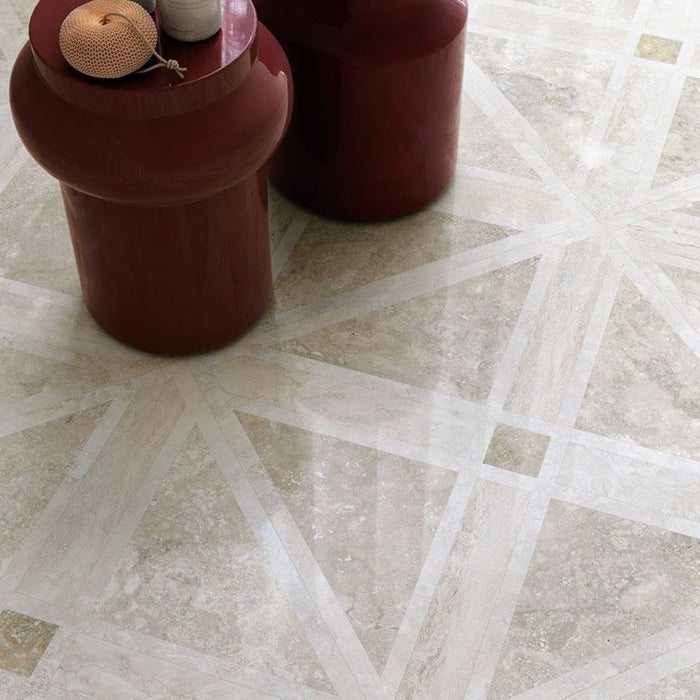 Close-up of Nucetto Travertine Decor 60x60cm wall and floor tiles, showcasing a geometric travertine effect pattern in warm neutral tones, styled with contemporary burgundy side tables for an elegant, modern finish.
