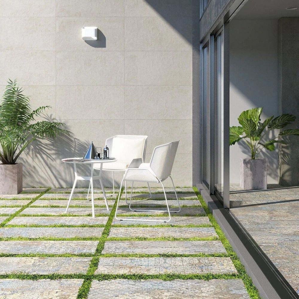 Outdoor seating area featuring Boho Ocean Blend 2cm 50 × 100cm patterned slabs, blending soft neutral and blue tones with a gently weathered effect. Ideal for patios and garden pathways, creating a relaxed, natural outdoor setting.