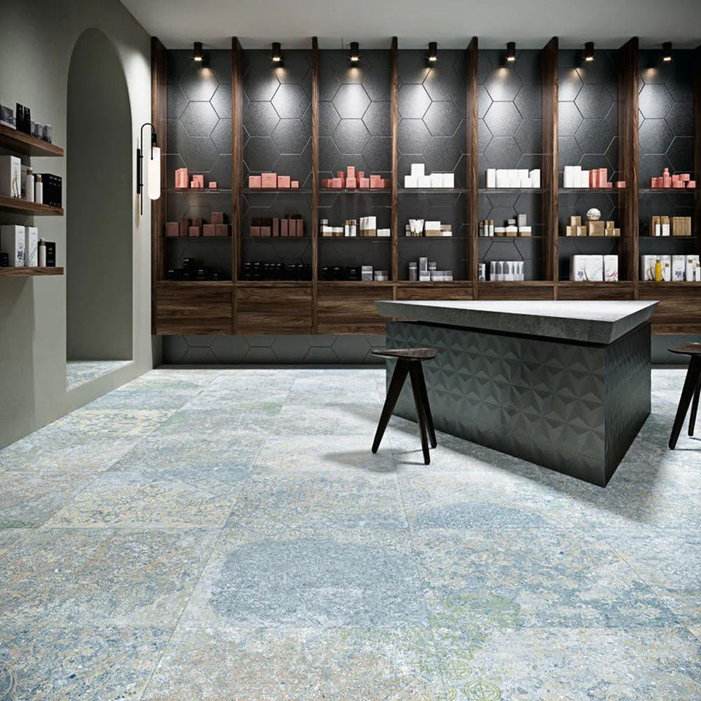 Interior featuring Boho Ocean Blue 60 × 60cm patterned floor tiles, blending soft blue and muted tones with a worn, decorative effect. Ideal for adding character to contemporary spaces such as retail interiors, kitchens, or open-plan living areas.