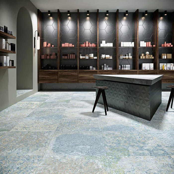 Interior featuring Boho Ocean Blue 60 × 60cm patterned floor tiles, blending soft blue and muted tones with a worn, decorative effect. Ideal for adding character to contemporary spaces such as retail interiors, kitchens, or open-plan living areas.