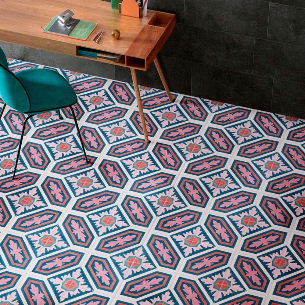Office interior featuring London Streets Conduit Street 20x20cm Victorian Moroccan style floor tiles, styled with a wooden desk, green chair and dark wall tiles, showcasing a bold pink, teal and white patterned floor design.