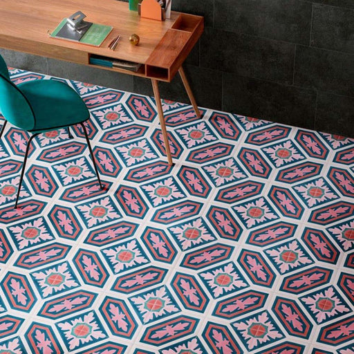 Office interior featuring London Streets Conduit Street 20x20cm Victorian Moroccan style floor tiles, styled with a wooden desk, green chair and dark wall tiles, showcasing a bold pink, teal and white patterned floor design.